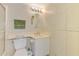 Well-lit bathroom with a vanity, toilet, and storage cabinets at 232 Saint Augustine Ave # 701, Venice, FL 34285