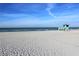 Lifeguard station on a sunny and expansive white sandy beach with ocean waves at 232 Saint Augustine Ave # 701, Venice, FL 34285
