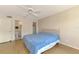 Cozy bedroom with wood floors and a ceiling fan, complemented by an adjacent bathroom and closet at 232 Saint Augustine Ave # 701, Venice, FL 34285