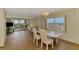 Elegant dining area with hardwood floors and balcony access showcases stunning water and skyline views at 232 Saint Augustine Ave # 701, Venice, FL 34285