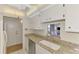 Bright kitchen with granite countertops, tile floors, and stainless steel dishwasher at 232 Saint Augustine Ave # 701, Venice, FL 34285