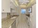 Well-lit kitchen with white appliances, granite countertops, and a ceiling fan at 232 Saint Augustine Ave # 701, Venice, FL 34285