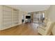 Bright living room with hardwood floors and a balcony with city views, creating a comfortable living space at 232 Saint Augustine Ave # 701, Venice, FL 34285