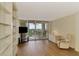 Spacious living room with hardwood floors, built-ins, and a balcony offering panoramic water views at 232 Saint Augustine Ave # 701, Venice, FL 34285