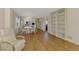 Cozy living room featuring hardwood floors, a white recliner, and built-in bookshelves for storage and display at 232 Saint Augustine Ave # 701, Venice, FL 34285