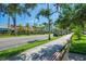 Sidewalk view of shops and restaurants along a palm tree-lined street under a blue sky at 232 Saint Augustine Ave # 701, Venice, FL 34285