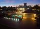 Night aerial view of home with an enclosed pool, patio, and attached two-car garage at 2322 Bayshore Rd, Nokomis, FL 34275