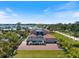 Aerial view of the home with a screened in pool, near waterfront, and a paver driveway at 2322 Bayshore Rd, Nokomis, FL 34275