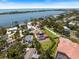 Waterfront property featuring lush landscaping, private dock, gorgeous waterway views, and a stunning residence at 2322 Bayshore Rd, Nokomis, FL 34275