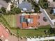 Aerial view of the home showcasing the pool, tile roof, circular driveway, and manicured lawns at 2322 Bayshore Rd, Nokomis, FL 34275
