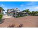 Large backyard features screened-in porch, pool, landscaping, and brick paver patio at 2322 Bayshore Rd, Nokomis, FL 34275