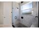 Contemporary shower features gray marble, black hardware, and glass enclosure at 2322 Bayshore Rd, Nokomis, FL 34275