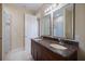 Bathroom features a granite countertop, double sinks, and tiled shower at 2322 Bayshore Rd, Nokomis, FL 34275
