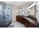 Modern bathroom boasts a glass shower, dual sinks, and stylish granite counters at 2322 Bayshore Rd, Nokomis, FL 34275