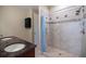 Comfortable bathroom boasts tiled shower, storage cabinet, and granite countertop at 2322 Bayshore Rd, Nokomis, FL 34275
