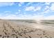 Beautiful beach view with footprints on the sand, showcasing a sunny and tranquil coastal environment at 2322 Bayshore Rd, Nokomis, FL 34275