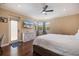 Bright bedroom features hardwood floors, white dresser, and a modern ceiling fan at 2322 Bayshore Rd, Nokomis, FL 34275