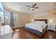 Comfortable bedroom featuring hardwood floors, a ceiling fan, and natural light from the window at 2322 Bayshore Rd, Nokomis, FL 34275