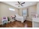 Cozy bedroom with dark hardwood floors, white bed, and modern ceiling fan at 2322 Bayshore Rd, Nokomis, FL 34275