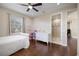 Bright bedroom boasting a large window, hardwood floors, a ceiling fan, and an ensuite bathroom at 2322 Bayshore Rd, Nokomis, FL 34275