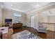 Bonus room with wood flooring, a ceiling fan, television, and workout equipment at 2322 Bayshore Rd, Nokomis, FL 34275