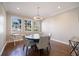 Dining room features hardwood floors, modern light fixture, and natural light from the windows at 2322 Bayshore Rd, Nokomis, FL 34275