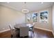 Well-lit dining room with hardwood floors, modern lighting, and bright windows with natural light at 2322 Bayshore Rd, Nokomis, FL 34275