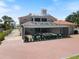 Exterior shot of the home, pool, rooftop deck, and brick paved patio at 2322 Bayshore Rd, Nokomis, FL 34275