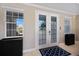 Bright foyer with decorative glass front door, front windows, and modern storage cabinet at 2322 Bayshore Rd, Nokomis, FL 34275