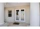Inviting front entrance with decorative glass doors and welcome mat at 2322 Bayshore Rd, Nokomis, FL 34275