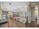Bright hallway features hardwood floors, coffered ceiling, and stylish railing to the lower level at 2322 Bayshore Rd, Nokomis, FL 34275