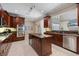 Beautiful kitchen featuring stainless steel appliances, an island, and custom wood cabinetry at 2322 Bayshore Rd, Nokomis, FL 34275