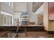 Open concept kitchen with granite countertops, stainless steel faucet, and views of the living area and fireplace at 2322 Bayshore Rd, Nokomis, FL 34275