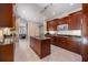 Spacious kitchen with dark wood cabinetry, stainless steel appliances, and a kitchen island with granite countertops at 2322 Bayshore Rd, Nokomis, FL 34275