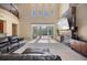 Open living room featuring a fireplace, soaring ceilings, and sliding glass doors to the pool area at 2322 Bayshore Rd, Nokomis, FL 34275