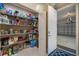 Walk-in pantry features metal shelving and ample storage space for household items and food at 2322 Bayshore Rd, Nokomis, FL 34275