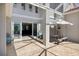 Outdoor patio with covered dining area, comfortable seating, and sliding glass doors to interior at 2322 Bayshore Rd, Nokomis, FL 34275