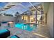 Stunning screened pool with plenty of room to enjoy the Florida sun with a firepit and seating at 2322 Bayshore Rd, Nokomis, FL 34275