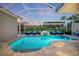 Inviting screened pool and fire pit with ample seating for outdoor entertaining at 2322 Bayshore Rd, Nokomis, FL 34275