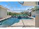 Screened in pool features lounge chairs and seating for entertaining at 2322 Bayshore Rd, Nokomis, FL 34275