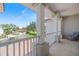 Second-story porch with a tiled floor, features white railings and columns with neighborhood views at 2322 Bayshore Rd, Nokomis, FL 34275