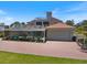 Beautiful rear exterior features screened-in pool, patio, and brick-paved driveway at 2322 Bayshore Rd, Nokomis, FL 34275