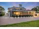 Rear exterior features screened-in pool, patio, and brick-paved driveway with lights at 2322 Bayshore Rd, Nokomis, FL 34275