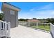 Roof deck features tile floors and railings with view of a lawn and neighborhood at 2322 Bayshore Rd, Nokomis, FL 34275