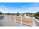 View from roof deck showing waterfront neighborhood with palm trees and beautiful blue sky at 2322 Bayshore Rd, Nokomis, FL 34275