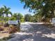 Street view of community featuring lush, mature landscaping and private entry at 2322 Bayshore Rd, Nokomis, FL 34275