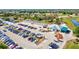 Aerial view of golf course and parking lot with cars and golf carts at 269 Mark Twain Ln, Rotonda West, FL 33947