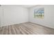 This bedroom features light wood floors, white walls and neutral trim to create a bright, airy and relaxing space at 269 Mark Twain Ln, Rotonda West, FL 33947