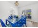 Charming dining area with blue wicker furniture, modern lighting, and view to the outdoor space at 269 Mark Twain Ln, Rotonda West, FL 33947