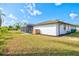 The exterior view highlights manicured landscaping and a backyard pool with screened enclosure at 269 Mark Twain Ln, Rotonda West, FL 33947